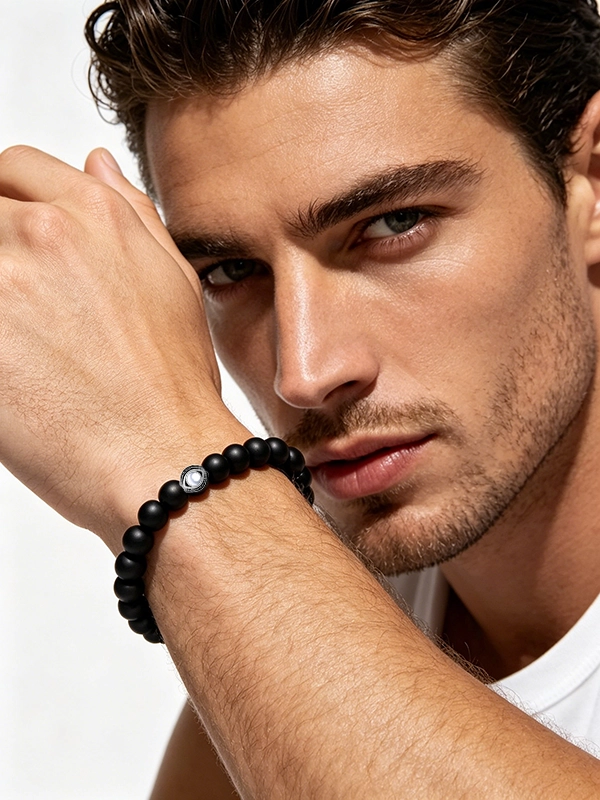 Close-up of a handmade black onyx evil eye bracelet for men featuring natural stone beads and a protective evil eye charm.